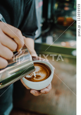 pouring milk for making latte art coffee pouring milk for making latte art coffee 111659359