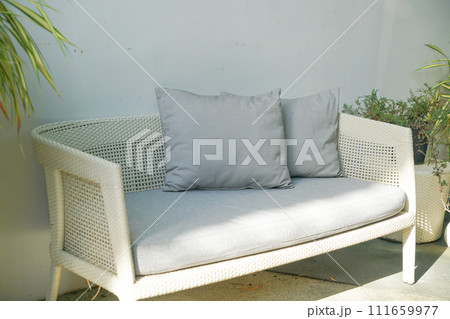 comfortable pillows on wicker chair 111659977