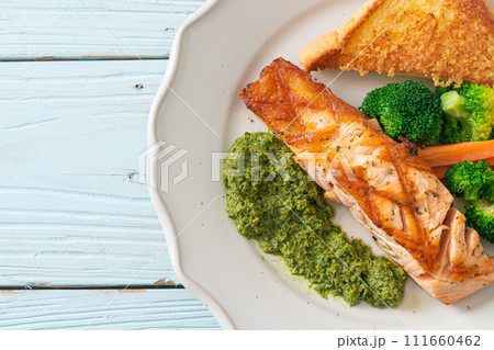 grilled salmon steak with pesto sauce 111660462