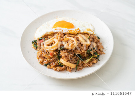 fried rice with squid and basil topped fried egg in Thai style 111661647