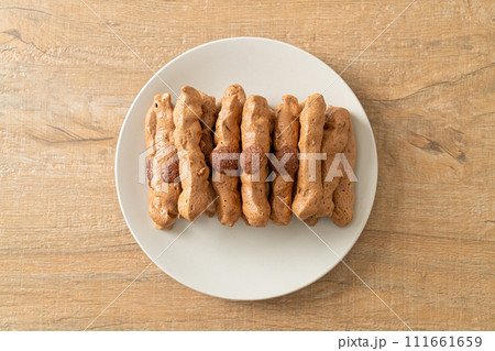 chocolate meringue stick on plate 111661659