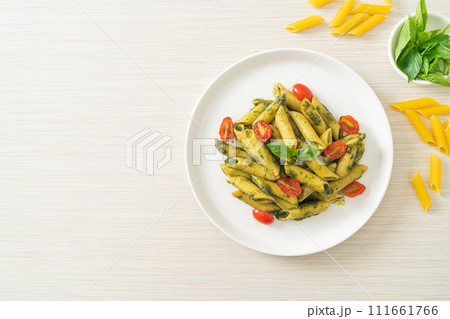 penne pasta with pesto sauce and tomatoes 111661766
