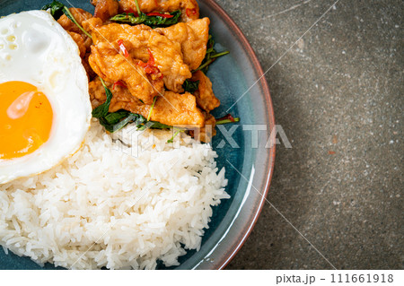 stir-fried fried fish with basil and fried egg topped on rice stir-fried fried fish with basil and fried egg topped on rice 111661918