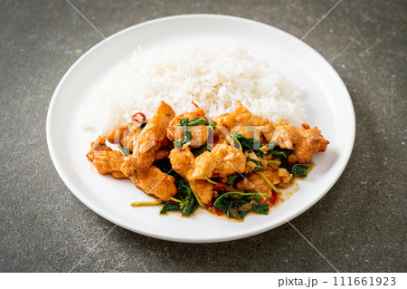 stir-fried fried fish with basil and chili in thai style topped on rice stir-fried fried fish with basil and chili in thai style topped on rice 111661923