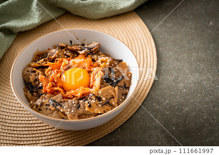 pork bulgogi rice bowl with kimchi and Korean pickled egg 111661997