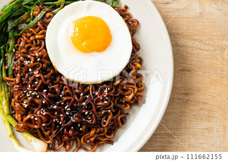 dried Korean spicy black sauce instant noodles with fried egg and kimchi dried Korean spicy black sauce instant noodles with fried egg and kimchi 111662155