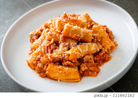 Rigatoni pasta bolognese with cheese 111662162
