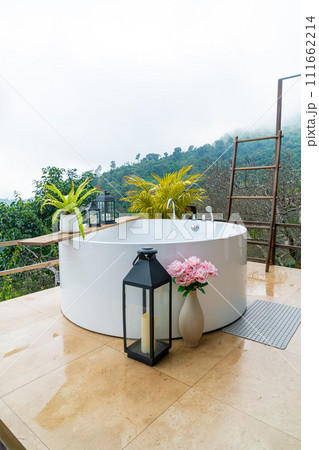 outdoor bath tub with beautiful mountain view background 111662214