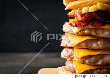 pork burger with cheese, bacon and french fries 111662231
