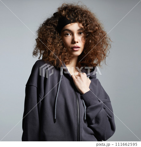 beautiful young woman in hoodie. pretty curly hairstyle girl 111662595