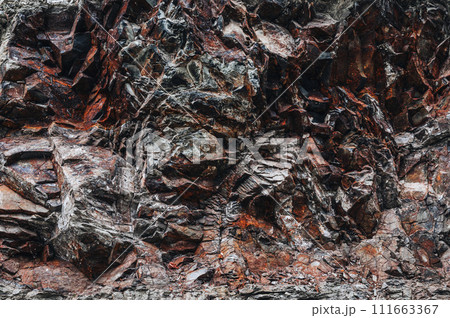 texture of orange stone mountain with natural minerals in close-up 111663367