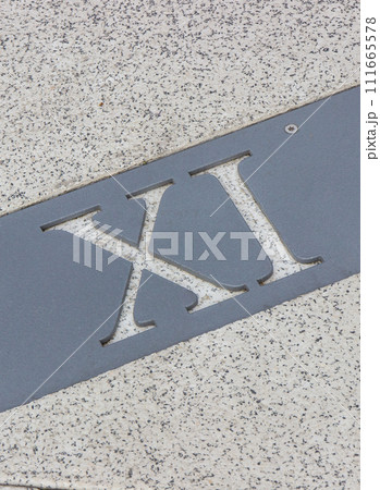 Roman numerical number eleven made of stone tiles on street Roman numerical number eleven made of stone tiles on street 111665578