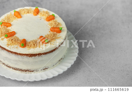 Homemade carrot cake made with walnuts, iced with cream cheese. Sweet dessert. Homemade carrot cake made with walnuts, iced with cream cheese. Sweet dessert. 111665619