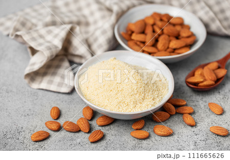 Fresh almond flour in a  bowl and almonds 111665626