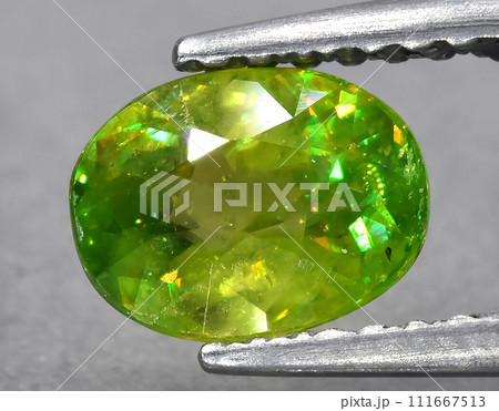 natural green sphene titanite gem on the background natural green sphene titanite gem on the background 111667513