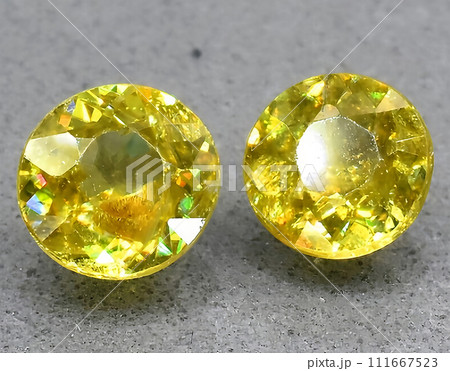 natural yellow sphene titanite gem on the background 111667523