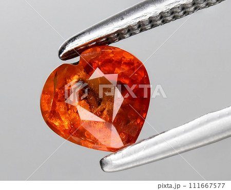 natural orange padparadscha sapphire gem on the background 111667577