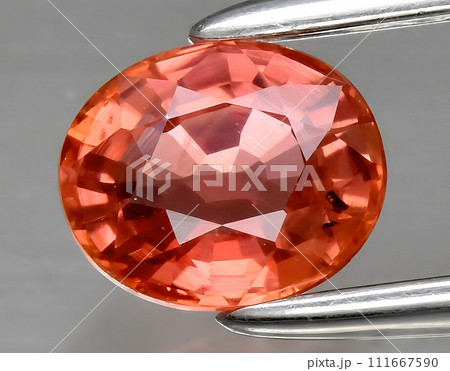 natural orange padparadscha sapphire gem on the background natural orange padparadscha sapphire gem on the background 111667590