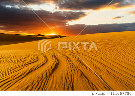 Sunset over the sand dunes in the desert. Sahara desert 111667786