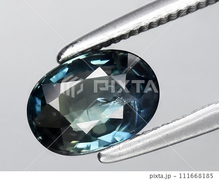 natural green blue sapphire gem on the background natural green blue sapphire gem on the background 111668185