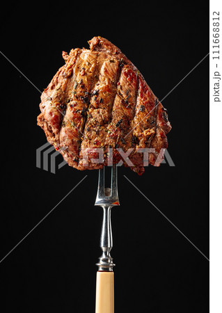 Beef steak on a fork. Beef steak on a fork. 111668812