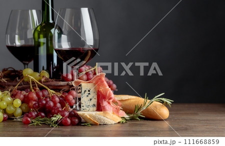 Delicious snack and glasses of red wine. Delicious snack and glasses of red wine. 111668859