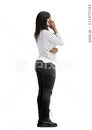 A woman, on a white background, in full height, with a phone 111672383