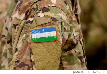 Puntland State of Somalia flag on soldiers arm. Puntland army (collage) Puntland State of Somalia flag on soldiers arm. Puntland army (collage) 111675262