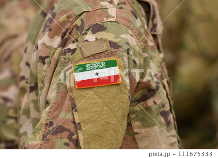 Somaliland flag on soldiers arm (collage). 111675333