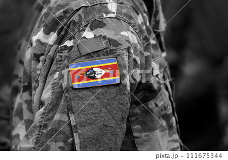 Kingdom of Eswatini, also known as Swaziland flag on soldiers arm. Eswatini flag on military uniform. Army, troops, military, Africa (collage). Kingdom of Eswatini, also known as Swaziland flag on soldiers arm. Eswatini flag on military uniform. Army, troops, military, Africa (collage). 111675344