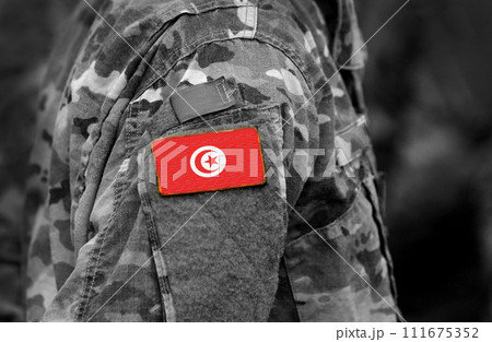Flag of Tunisia on soldiers arm (collage). 111675352