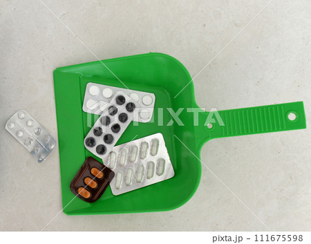 Health concept. pills in a scoop for garbagea. throwing pills away 111675598