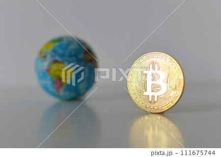 Bitcoin concept. World economy concept. New world currency.Golden coin bitcoin and globe. Bitcoin concept. World economy concept. New world currency.Golden coin bitcoin and globe. 111675744