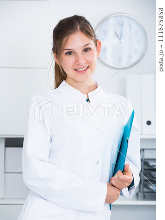 Female doctor in lab coat with clipboard Female doctor in lab coat with clipboard 111675858