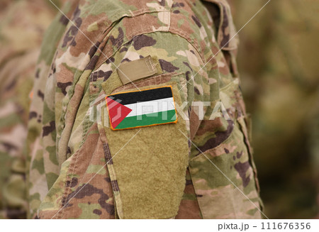 State of Palestine flag on soldiers arm (collage). State of Palestine flag on soldiers arm (collage). 111676356