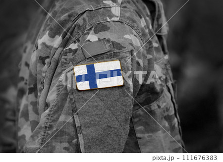 Finland flag on soldiers arm (collage). 111676383