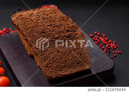 Delicious brown bread with seeds and grains cut into slices 111676844
