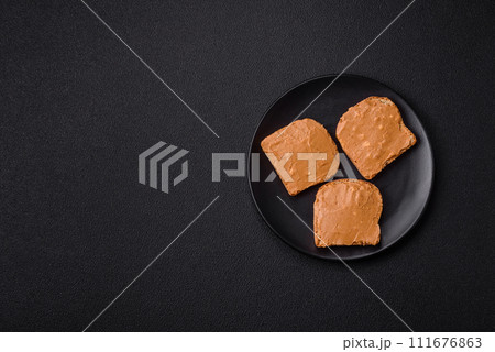 Delicious hearty sandwich with toast bread and peanut butter 111676863