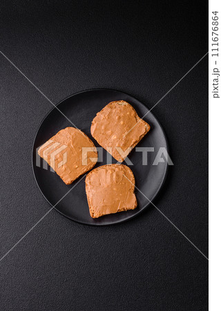 Delicious hearty sandwich with toast bread and peanut butter 111676864