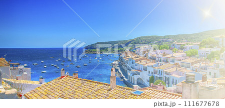 View on Street in Cadaques, Catalonia, Spain near of Barcelona. Scenic old town with nice beach and clear blue water in bay. Famous tourist destination in Costa Brava with Salvador Dali landmark 111677678