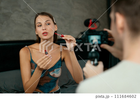 Young woman making beauty and cosmetic tutorial video content. Unveiling Young woman making beauty and cosmetic tutorial video content. Unveiling 111684602