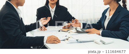 Corporate accountant team use calculator to calculate financial report. Shrewd Corporate accountant team use calculator to calculate financial report. Shrewd 111684677