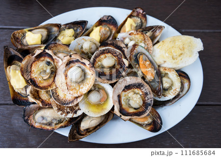 grilled butter scallop, mussel, and bread. family barbeque dinner 111685684