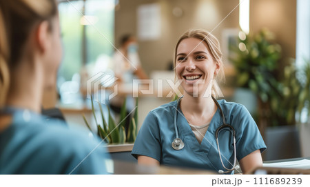 A smiling healthcare worker greeting a patient at the reception of a clinic, creating a welcoming atmosphere 111689239
