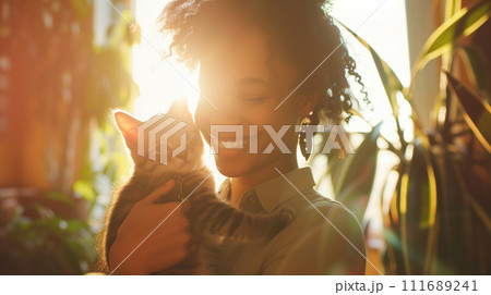 A smiling person holding a pet, captured in a warm, sunlit space, illustrating the role of companionship in mental health 111689241