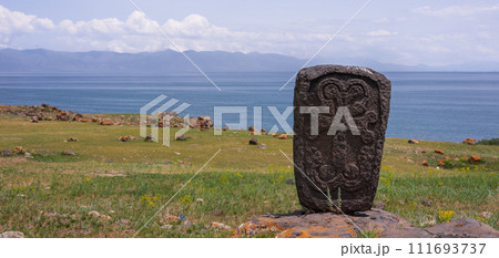 Armenian architectural shrines - ancient khachkars near the Artsvatrich chapel on the shore of Lake Sevan Armenian architectural shrines - ancient khachkars near the Artsvatrich chapel on the shore of Lake Sevan 111693737