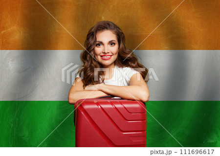 Welcome to India. Young happy woman with red suitcase on Indian flag background. Welcome to India. Young happy woman with red suitcase on Indian flag background. 111696617