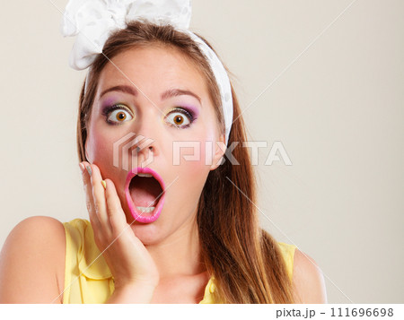 Amazed surprised pin up girl with mouth wide open. 111696698