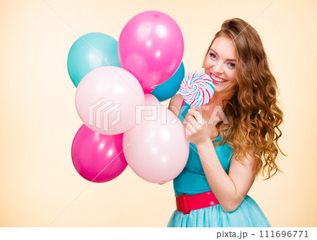 Woman with colorful balloons and lollipop Woman with colorful balloons and lollipop 111696771