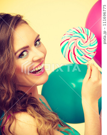 Woman with colorful balloons and lollipop 111696775